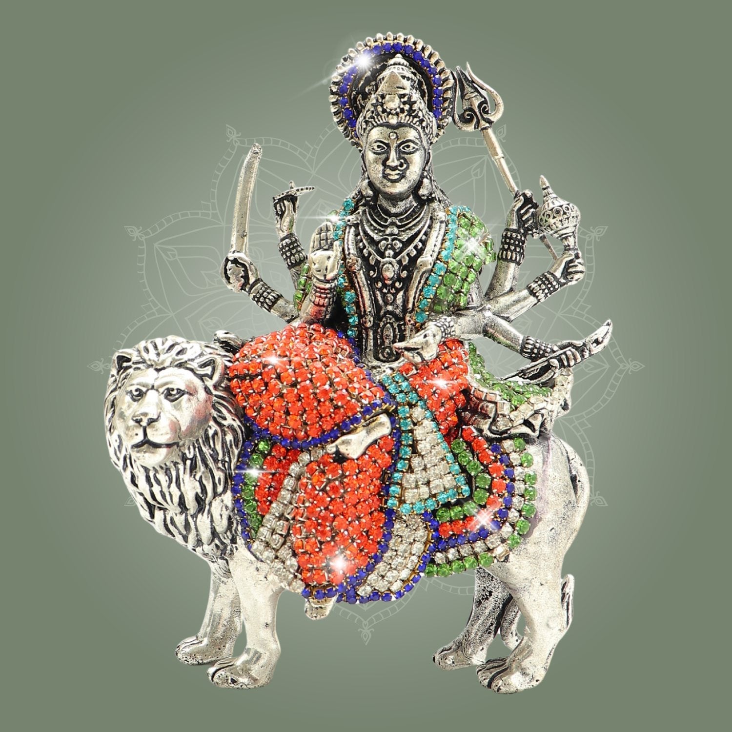 Decorative figurine of a deity on a lion with colorful embellishments on a gray background